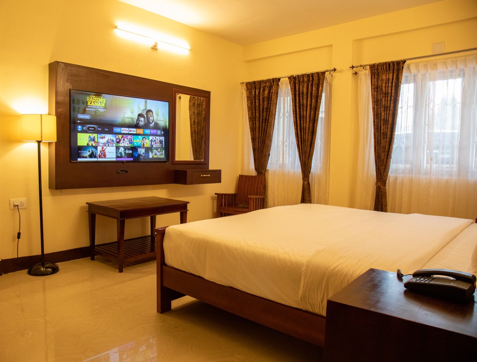 Luxury room at Aakash with a large bed and seating