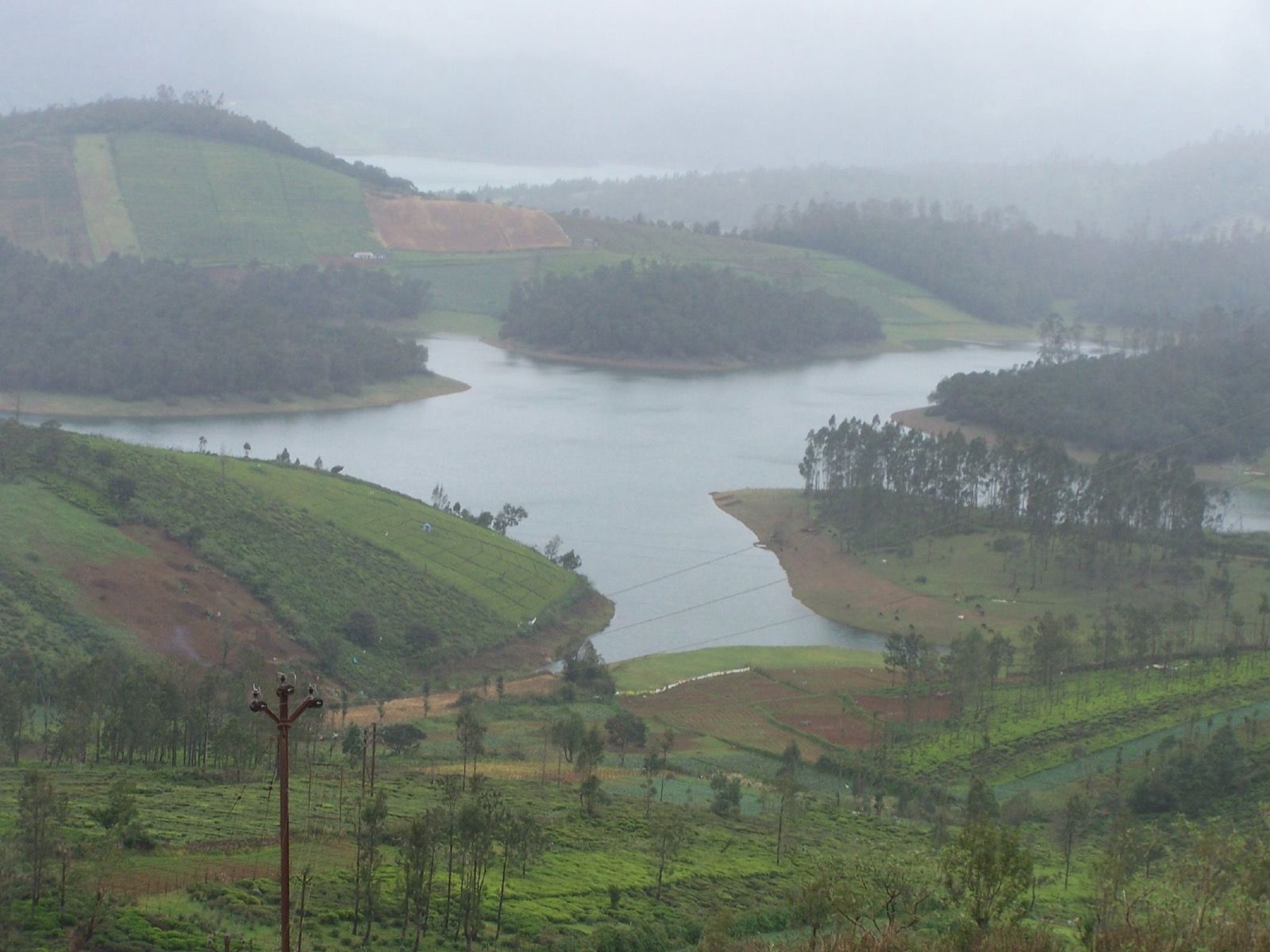 Still water and wooded hills at Avalanche Lake near Ooty